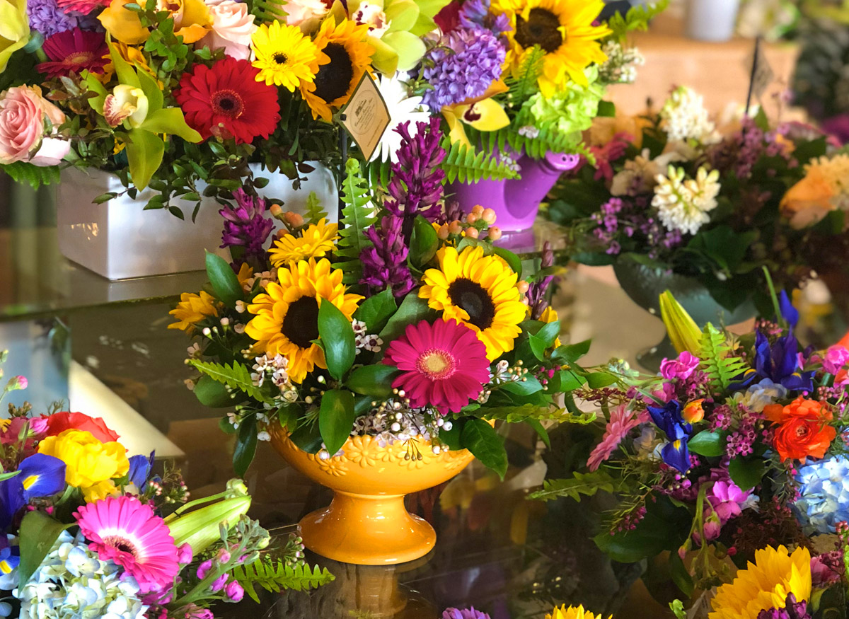 A wide range of colorful floral arrangements, awaiting their new home